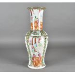 A Canton Famille Rose porcelain baluster vase, decorated with panels of court life, and birds,