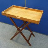 An oak butlers tray on mahogany folding stand