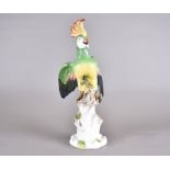 A 19th Century Volkstedt porcelain model of a parrot, depicted upon naturalistic base, coloured in