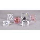 A group of five lead crystal paperweights by Hubertushütte, various shapes, two with pink trails,