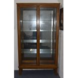 An early 20th Century oak glazed display cabinet by The Lantern Galleries, Leicester Road,