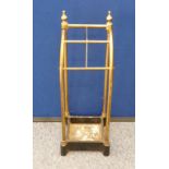 A brass four division stick stand with cast metal base