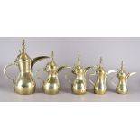 A set of five vintage graduated Middle-Eastern brass coffee pots, smallest 26.5 cm high, largest