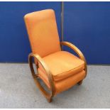 An Art Deco oak cottage rocking arm chair, patterned red fabric