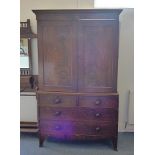 A Victorian mahogany linen press, two panel doors over two short and three long drawers, interior