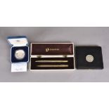 A Sheaffer gilt pen set comprising ballpoint pen and pencil in a fitted case, together with a