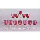 A set of 12 associated wine glasses with cranberry bowls and colourless stems, each c. 12.5 cm