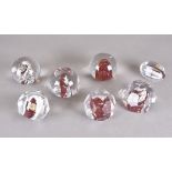 A group of seven lead crystal paperweights by Hubertushütte with silver and granulated red