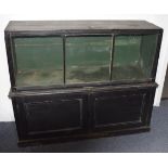 An ebonised shop display cabinet, with glazed fall down front above a pair of panel doors, 126 cm