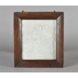 A KPM porcelain lithophane plaque, depicting two fashionable ladies and child, in an oak frame,