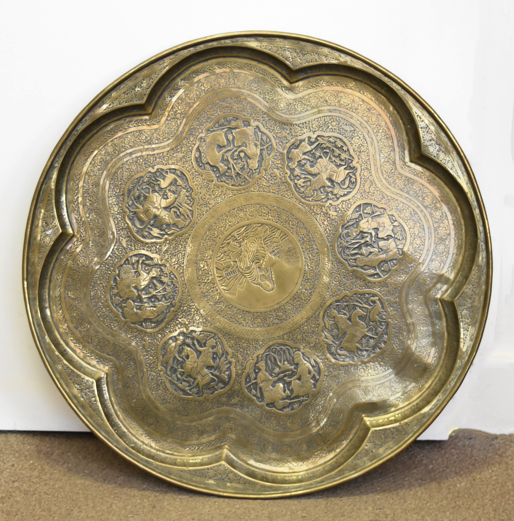 A 19th Century Persian large brass circular tray, the well of octofoil form with central medallion