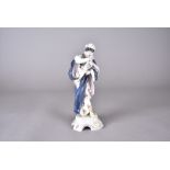 A Continental porcelain figurine, modelled as Winter by Naples Porcelain, painted in colours,