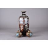 A pair of cloisonne squat circular vases, dome lids and flower head finials, 9 cm high, together