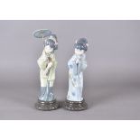 Two Lladro figurines, modelled as Japanese Geishas one with parasol, 29 cm high and another