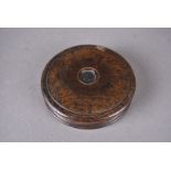 A 19th Century oak circular snuff box, the turned box centred with silver Victorian coin, 8.2 cm