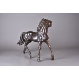 A pair of modern hollow cast bronzed horses, modelled standing on four legs with raised heads, 69 cm