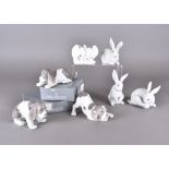 A collection of Lladro figurines, including rabbits, dogs and other porcelain figurines, all boxed