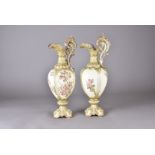 A pair of 19th Century continental porcelain ewers, ovoid lobed bodies with floral sprays heightened