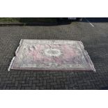 A modern Chinese cotton floral carpet, with central medallion on pink ground with a multiple border,