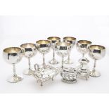 A collection of silver plated items, including a pair of entrée dishes, a set of eight goblets,