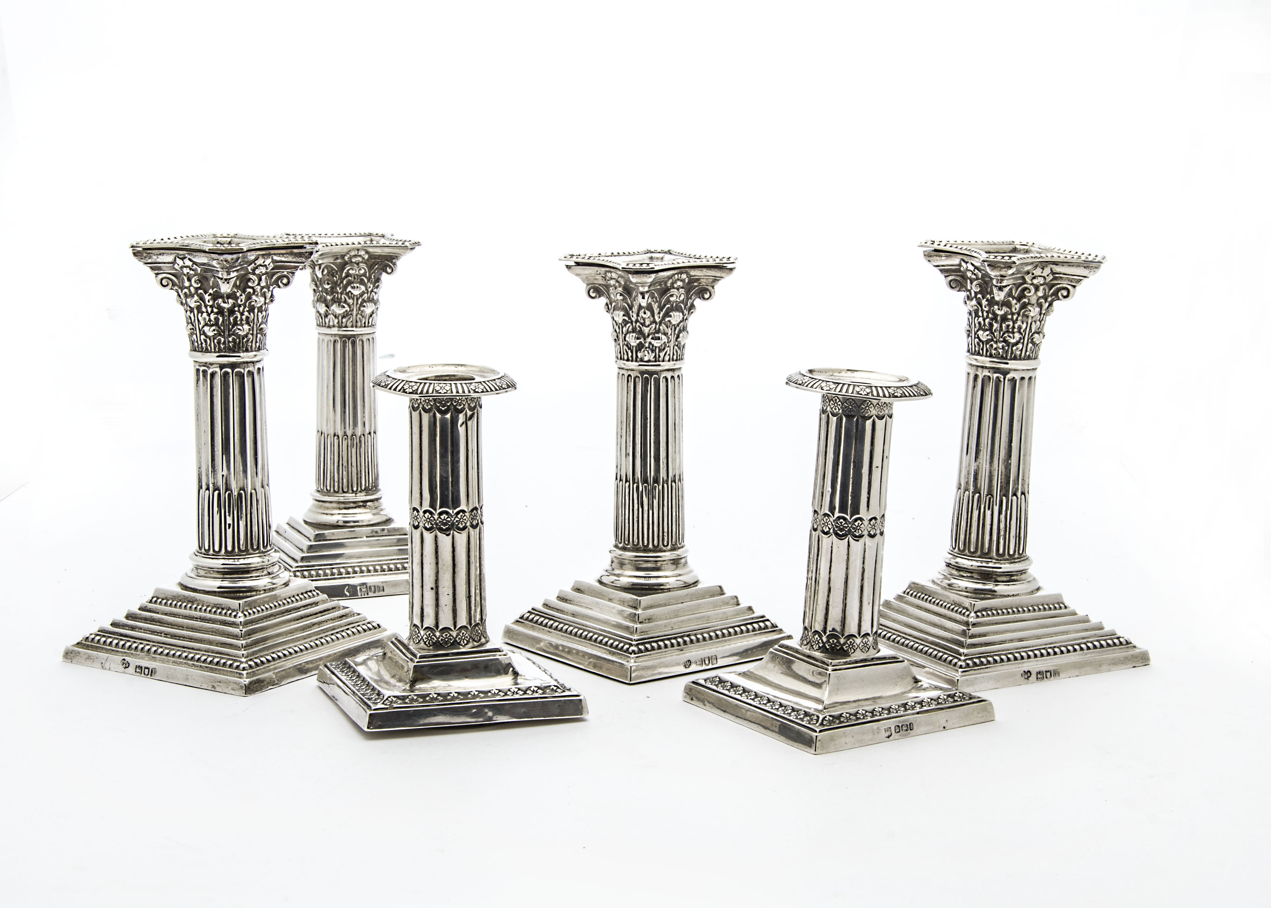 Three pairs of Victorian and later silver filled column candlesticks, two Corinthian form, and one