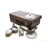 A George V silver dressing table set, comprising a pair of hair and clothes brushes, a hand mirror