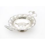 An Art Nouveau style silver plated twin handled comport, having the head of a female to well and