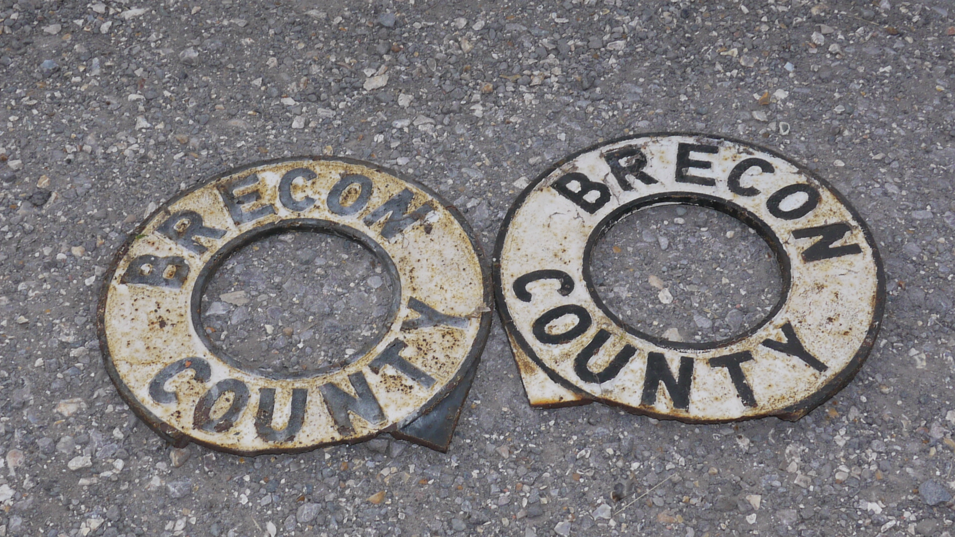 Brecon County Signs, A duo of original cast iron circular ring form post mounted signs, black on