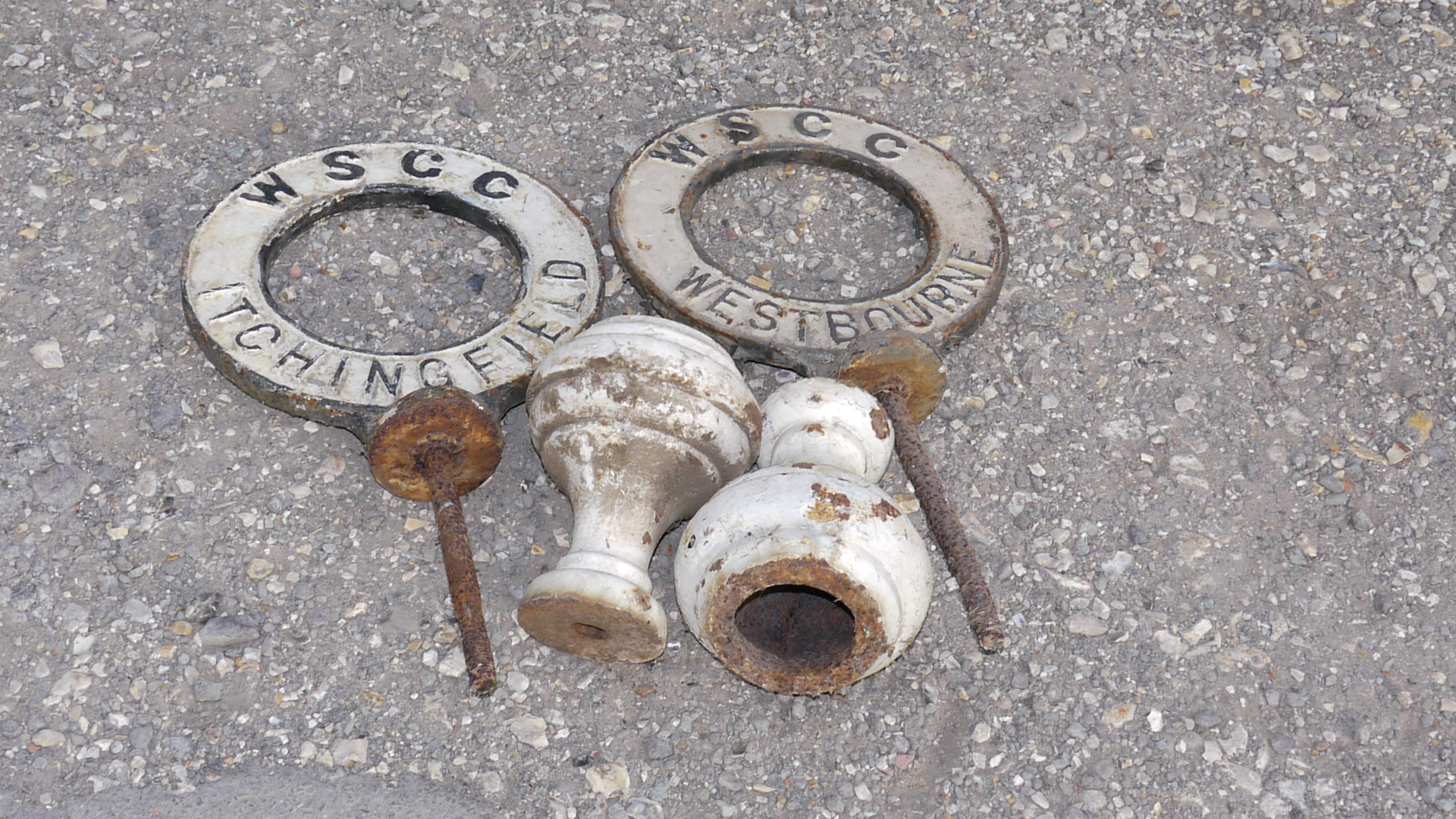 Westbourne and Itchingfield Signs, A duo of original double sided cast iron ring form post top signs