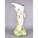 An art nouveau style large pottery vase, modelled as a maiden against foliage, 64 cm high