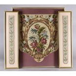 An embroidered fire screen, decorated with floral cartouche, 49.2 cm x 40.5 cm, framed and glazed.