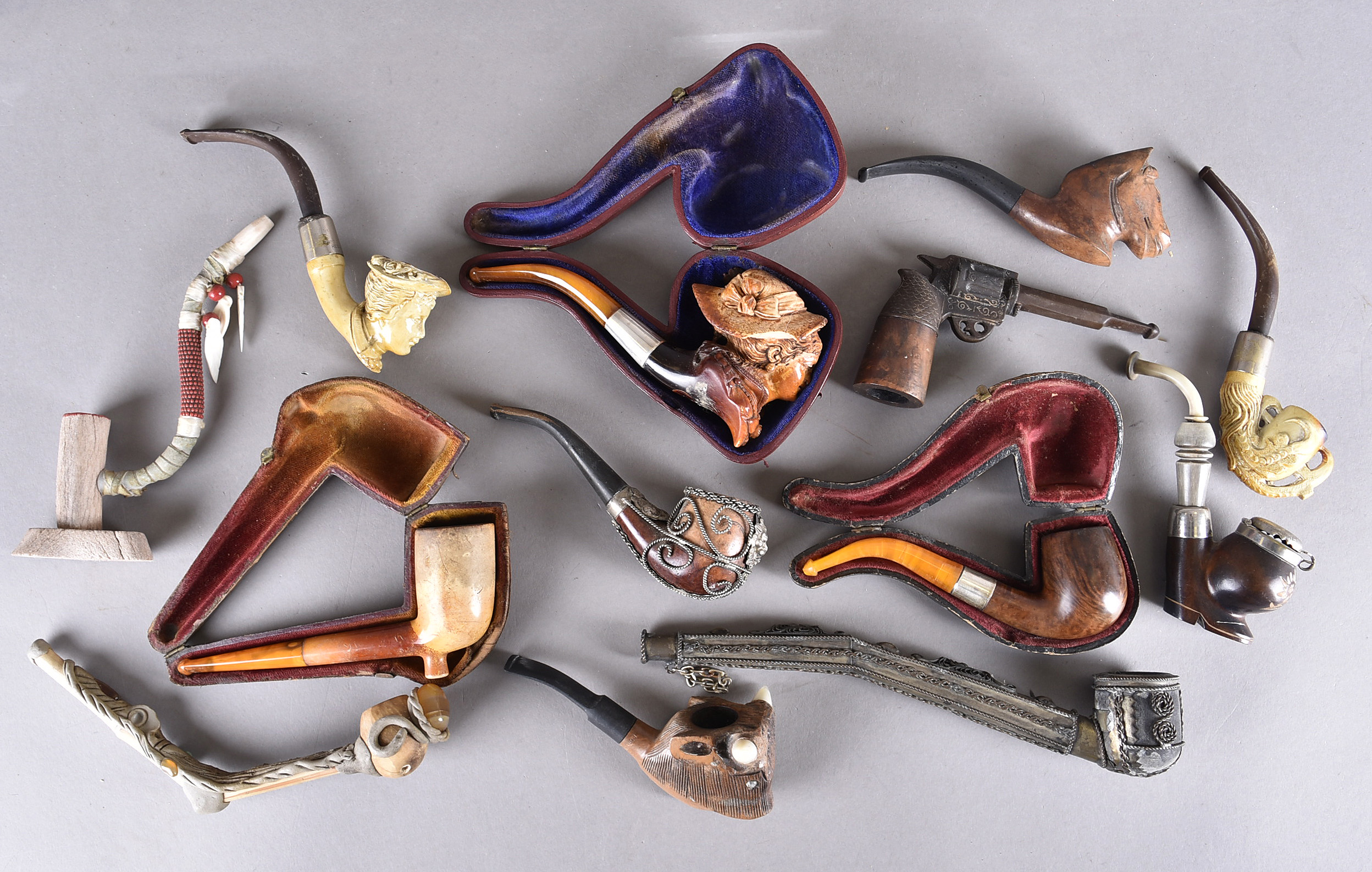A miscellaneous collection of pipes, including three with amber stems