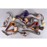 A miscellaneous collection of pipes, including three with amber stems