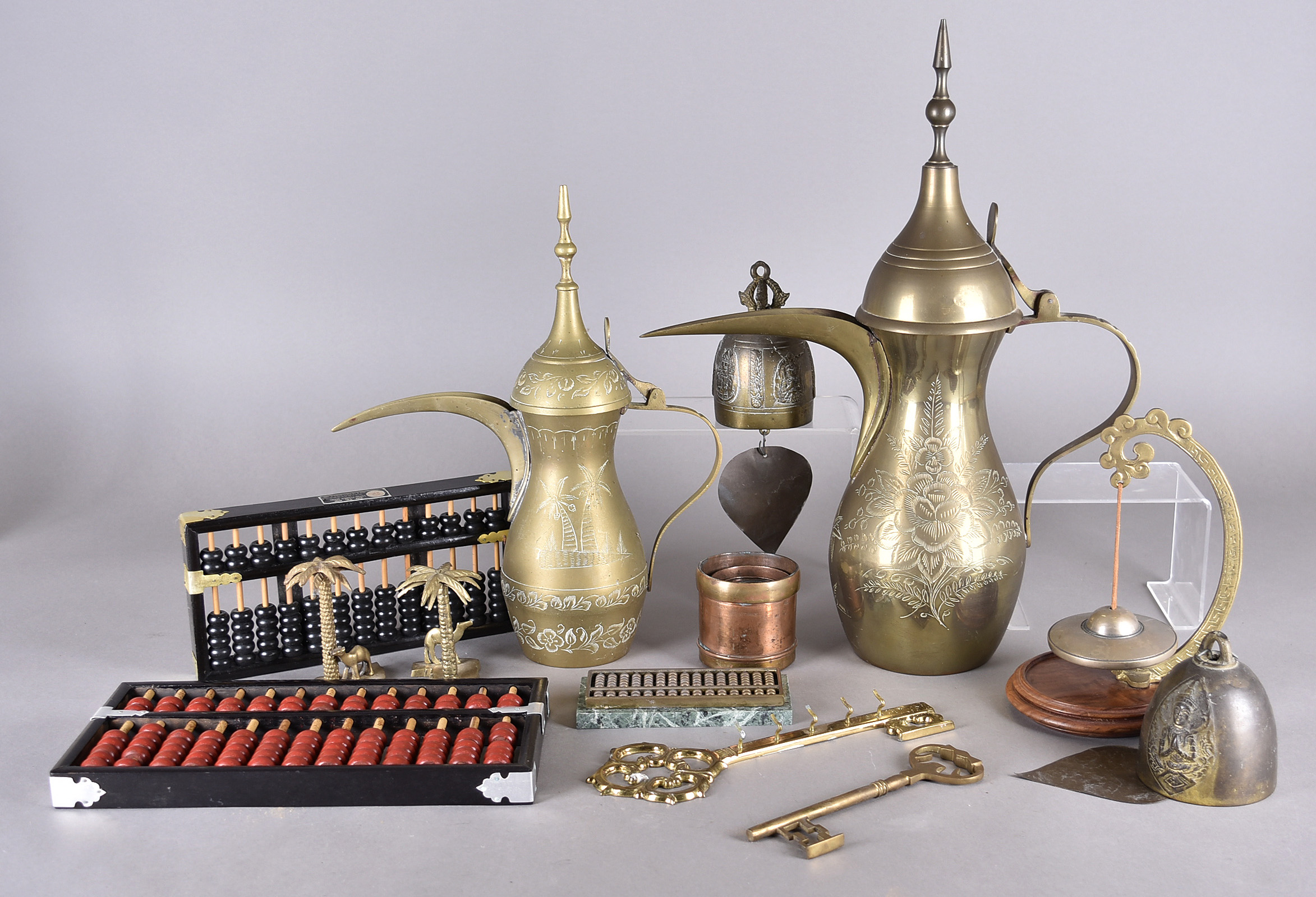 A collection of Middle Eastern coffee ewers, all in brass of various sizes together with two