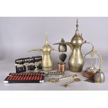 A collection of Middle Eastern coffee ewers, all in brass of various sizes together with two