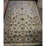 A kamali design cream ground floral rug 135 cm x 190 cm together with three gilt framed