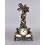 A spelter mantel clock, with eight day movement surmounted by a winged cherub playing the lyre,