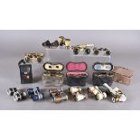 A collection of opera glasses, including some field examples, some in mother of pearl, others in