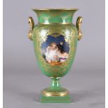 A French porcelain twin handled vase, in the Sevres style, the classical urn shape with an apple