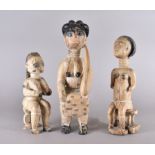 Three Ashanti female figures, 35cm, 29cm and 40cm high (3)