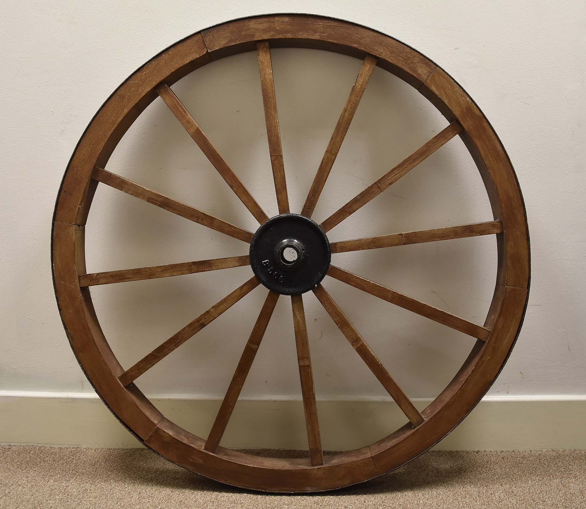 A Victorian oak and iron cart wheel, the central cog marked B566, 105 cm diameter