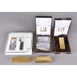 A collection of modern lighters including two Dunhill gold plated examples, a Cartier Briquet