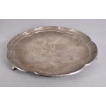 A George VI silver salver of circular ogee form supported on three scroll bracket feet, Sheffield