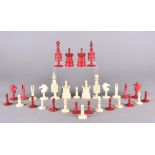 A 19th Century bone set of chess men in natural and stained red, all on turned circular bases (32)