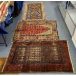 A Caucasian woolen rug, five terracotta and green geometric guls on indigo field, geometric