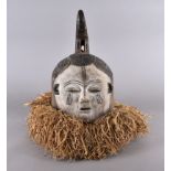 An Igbo mask with raffia decoration, 41 cm high