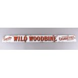 A 20th Century enamel advertising sign for 'Wild Woodbine', the white ground with the legend '