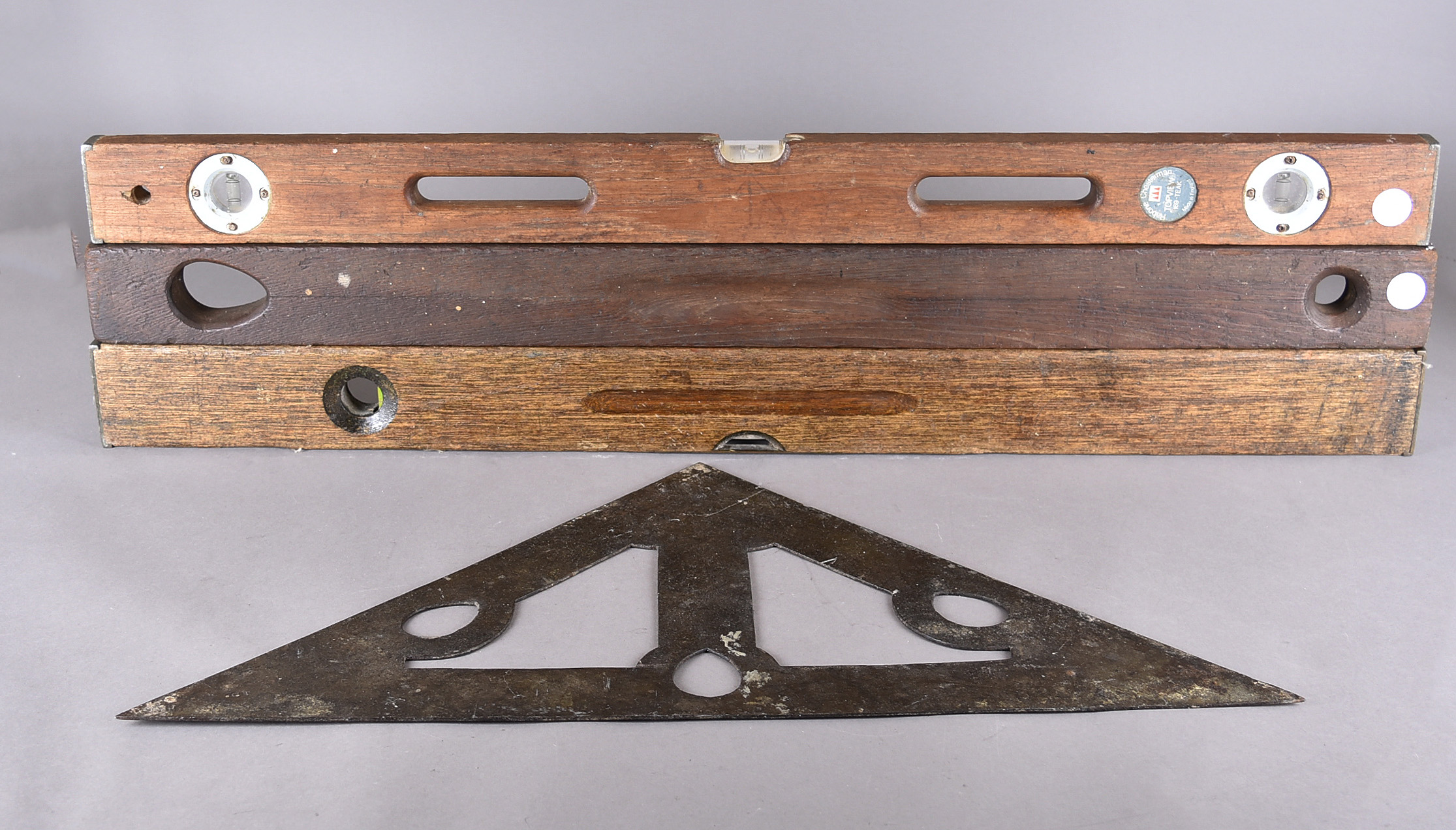 A Victorian cast iron mason's spirit level, of triangular shape, with cut out design, with