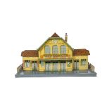 A JEP O Gauge Large Station, finely printed with yellow-rendered and red-brick walls, and green '