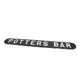 Potters Bar Railway Station Bench Sign, a GNR cast metal sign originally mounted on a platform bench